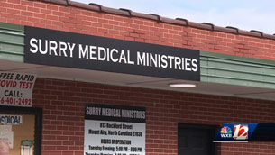 A sign on the side of a building that says surrey medical ministries.