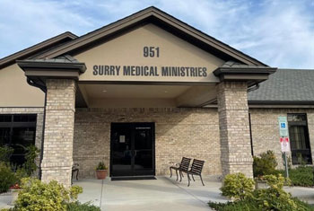 A building with the name surry medical ministries written on it.