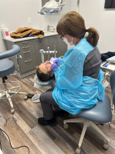 Gina Domingos, Dental Hygienist, provides care for a patient of Moore Free and Charitable Clinic’s new dental clinic.